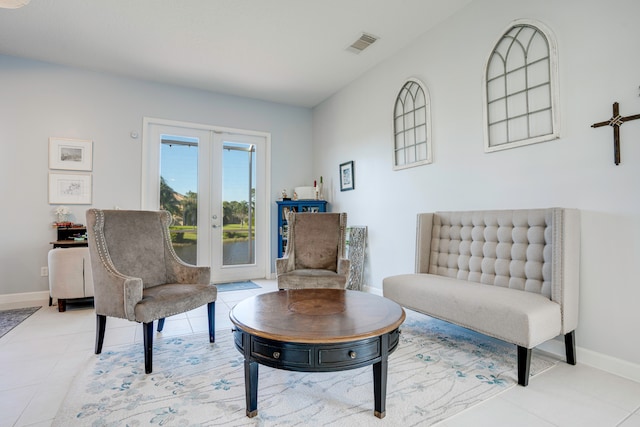 sitting room featuring light tile patterned floors and french doors