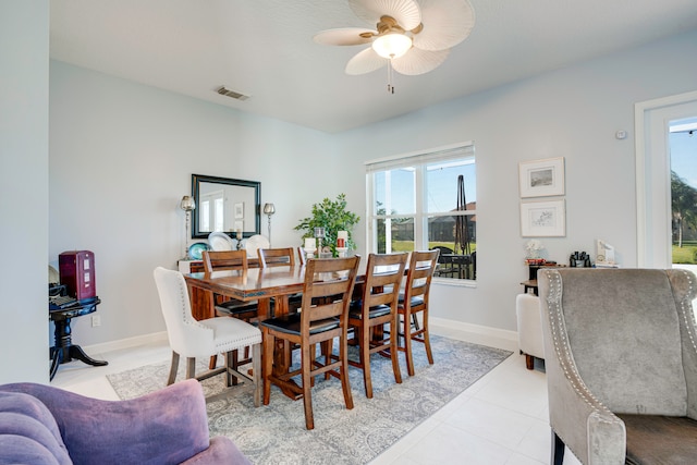 tiled dining area featuring ceiling fan