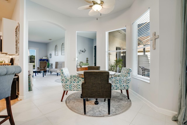 tiled dining room featuring ceiling fan