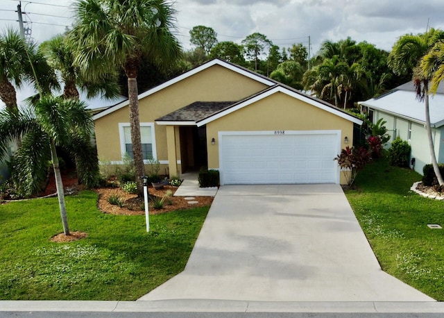 ranch-style home with a front yard and a garage