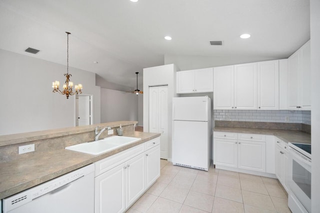 kitchen with sink, lofted ceiling, white appliances, white cabinets, and ceiling fan with notable chandelier