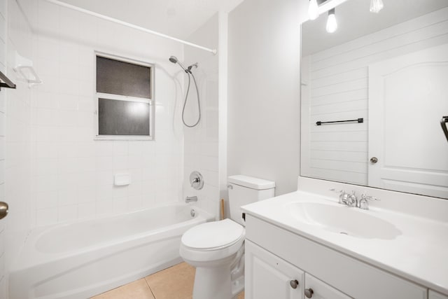 full bathroom featuring toilet, tile patterned flooring, vanity, and tiled shower / bath