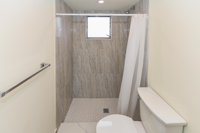 full bathroom featuring toilet and a shower stall