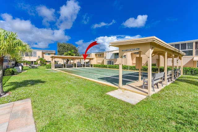 view of home's community featuring a yard and shuffleboard