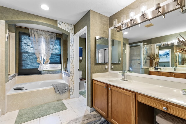 full bathroom with vanity, tile patterned floors, toilet, and separate shower and tub