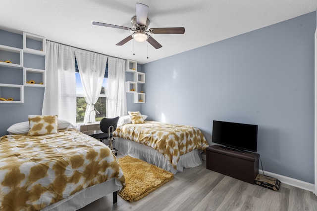 bedroom with ceiling fan and light hardwood / wood-style flooring