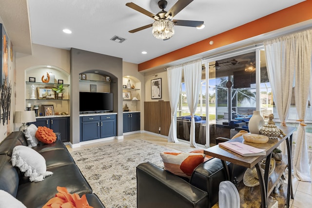 tiled living room featuring built in features, a wealth of natural light, and ceiling fan