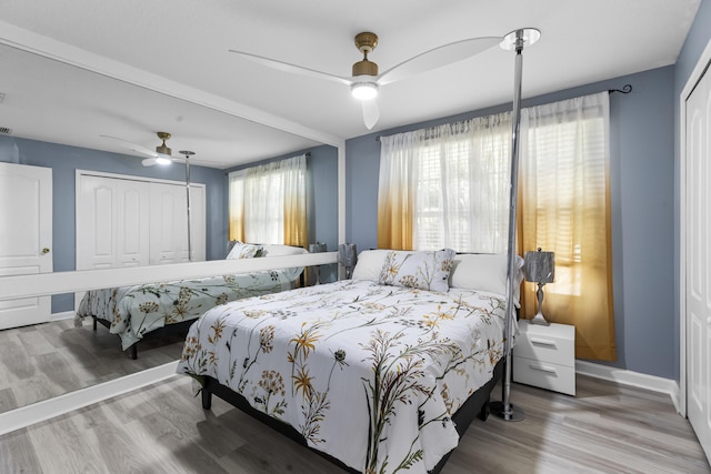 bedroom featuring a closet, hardwood / wood-style floors, and ceiling fan