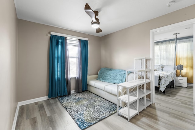 living room featuring wood-type flooring and ceiling fan