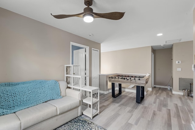 recreation room with ceiling fan and light hardwood / wood-style flooring