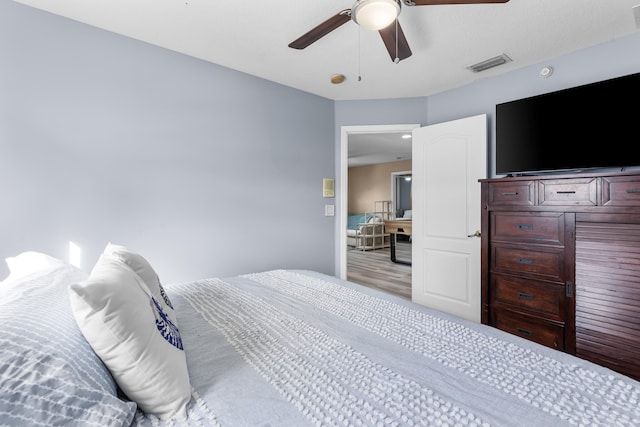 bedroom featuring light hardwood / wood-style floors and ceiling fan