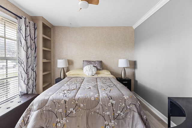 bedroom with ornamental molding, multiple windows, and ceiling fan