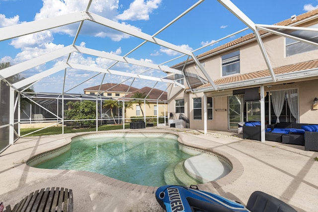 view of pool with an outdoor hangout area, a patio area, and a lanai