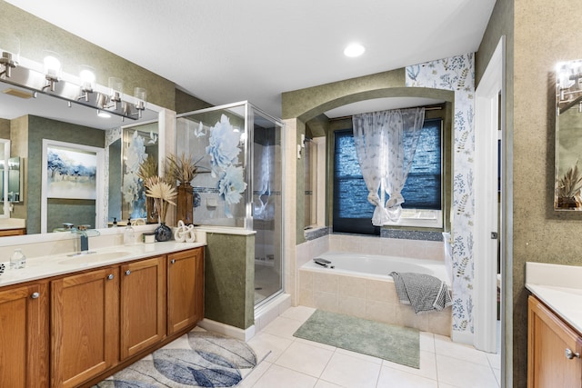 bathroom featuring vanity, shower with separate bathtub, and tile patterned flooring