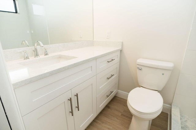 bathroom featuring vanity, toilet, and hardwood / wood-style floors