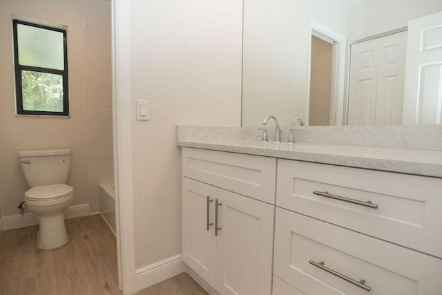 bathroom featuring hardwood / wood-style flooring, vanity, and toilet