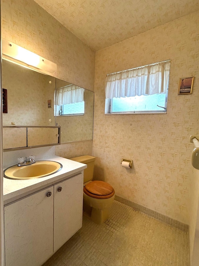 bathroom featuring toilet and vanity