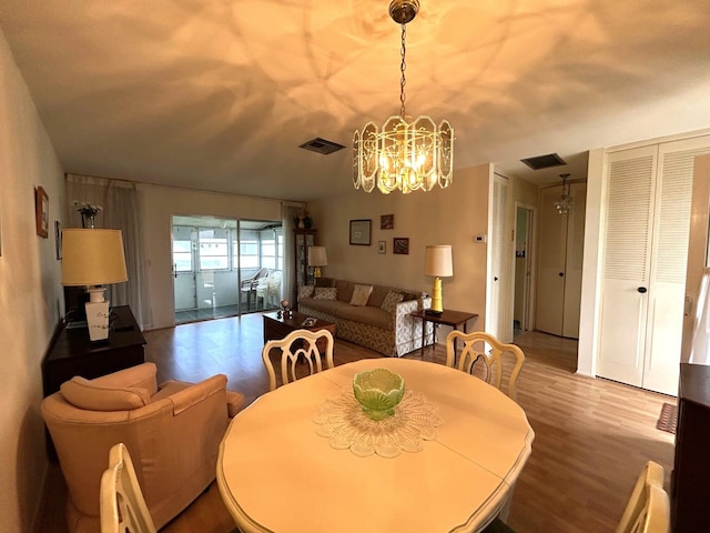 dining room with a chandelier and wood finished floors
