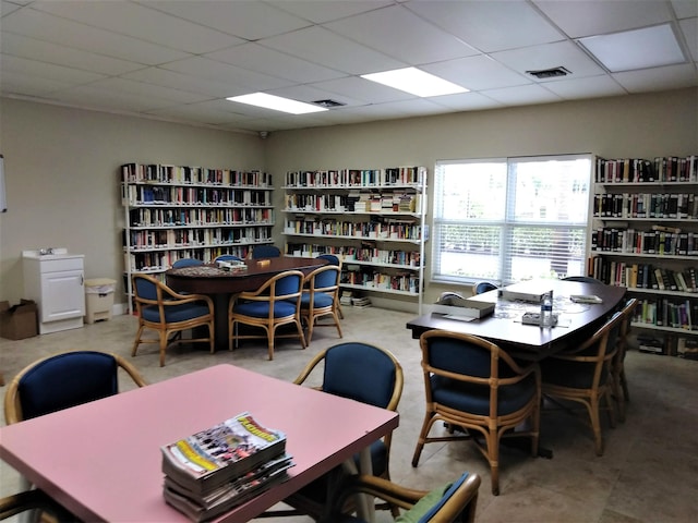 dining room featuring a drop ceiling