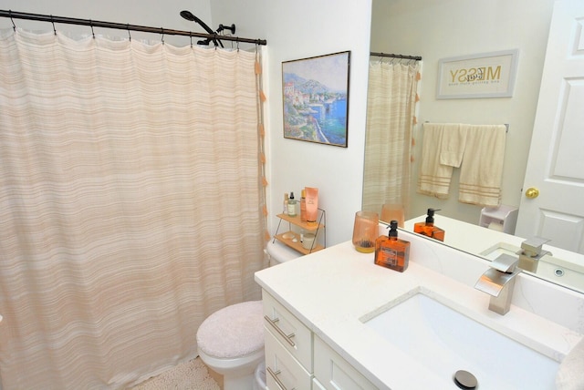 bathroom featuring toilet and vanity