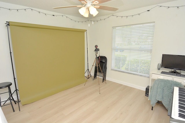 office with a textured ceiling, light hardwood / wood-style flooring, and ceiling fan