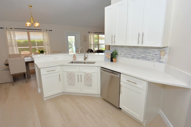 kitchen with sink, kitchen peninsula, decorative light fixtures, white cabinets, and dishwasher