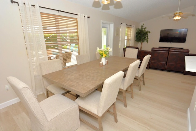 dining space featuring lofted ceiling, ceiling fan, and light hardwood / wood-style flooring