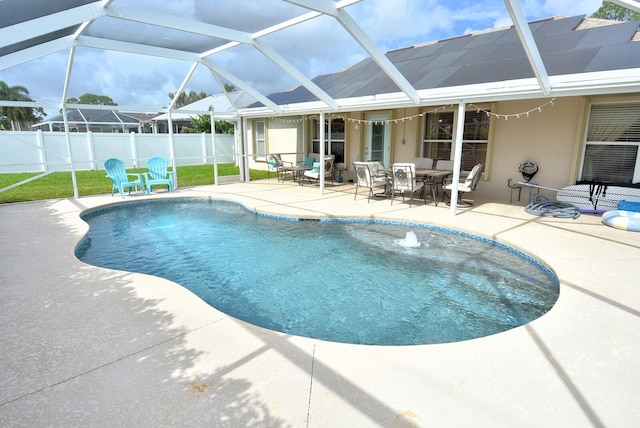 view of pool with a lanai, a patio, and pool water feature