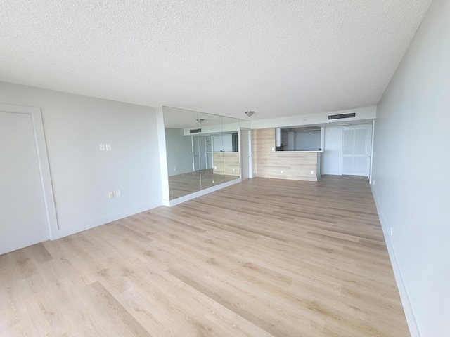 interior space featuring a textured ceiling and hardwood / wood-style flooring