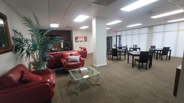 carpeted living room with a paneled ceiling