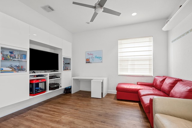 living room with ceiling fan and hardwood / wood-style flooring