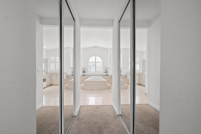 interior space featuring carpet flooring and lofted ceiling