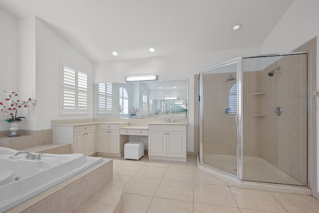 bathroom featuring tile patterned flooring, shower with separate bathtub, vanity, and lofted ceiling