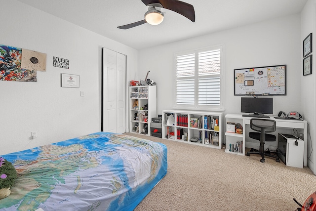 carpeted bedroom featuring ceiling fan and a closet