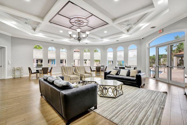 living room featuring ornamental molding, light wood-type flooring, french doors, and coffered ceiling