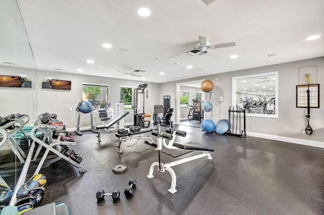 gym with ceiling fan and a textured ceiling