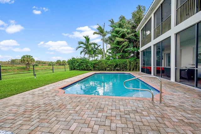 view of swimming pool with a yard and a patio area