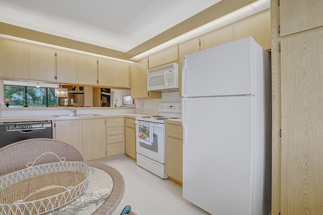 kitchen with light brown cabinetry, white appliances, sink, and light tile patterned floors