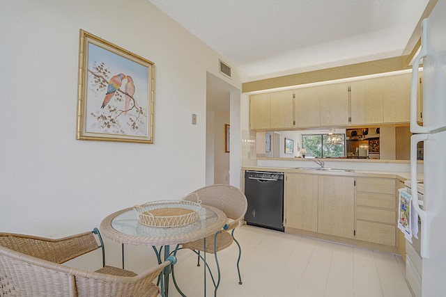 kitchen featuring white refrigerator, black dishwasher, kitchen peninsula, sink, and light brown cabinets