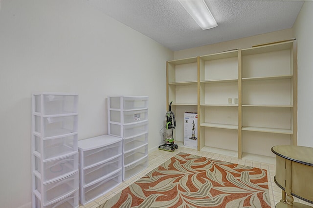 misc room featuring a textured ceiling and light tile patterned floors