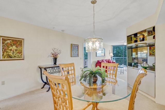 dining space with light colored carpet and an inviting chandelier