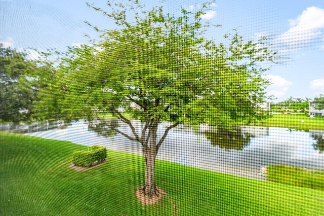 unfurnished sunroom featuring a water view