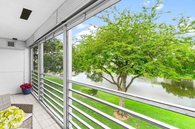 unfurnished sunroom with a water view