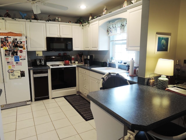 kitchen featuring white cabinetry, white appliances, light tile patterned floors, kitchen peninsula, and ceiling fan