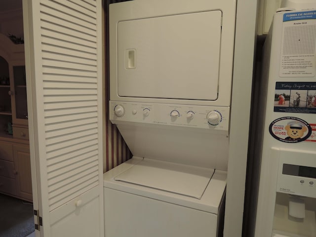 clothes washing area with stacked washer and clothes dryer