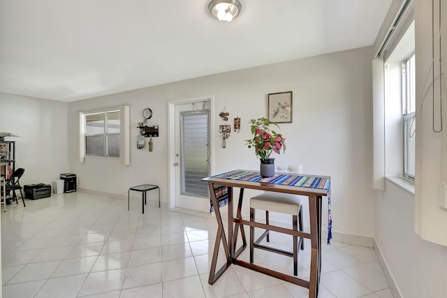 dining space with light tile patterned floors and plenty of natural light