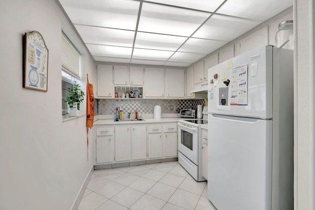 kitchen featuring light tile patterned flooring, a paneled ceiling, backsplash, custom exhaust hood, and white appliances