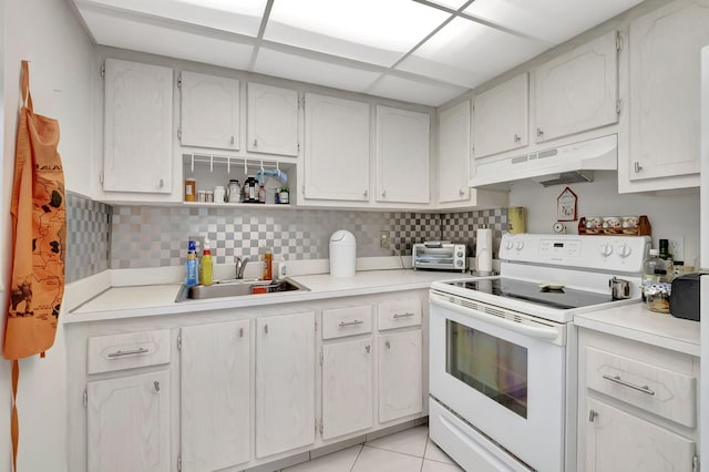 kitchen featuring white cabinetry, sink, a paneled ceiling, light tile patterned floors, and white electric stove