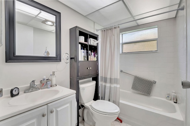 full bathroom featuring vanity, shower / bath combo, toilet, and a paneled ceiling