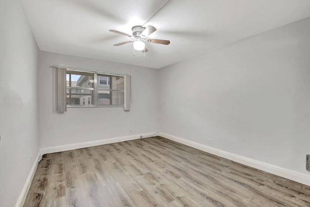 spare room featuring light hardwood / wood-style flooring and ceiling fan